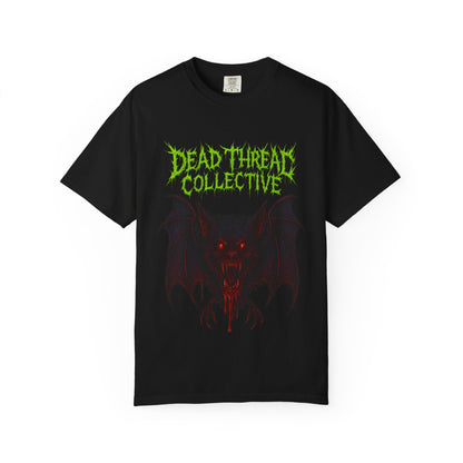 Black t-shirt featuring a blood-dripping vampire bat with glowing red eyes and sharp fangs, framed by jagged neon green and red text reading "Dead Threat Collective" in a horror-style font.