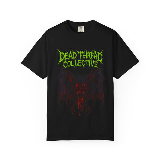 Black t-shirt featuring a blood-dripping vampire bat with glowing red eyes and sharp fangs, framed by jagged neon green and red text reading "Dead Threat Collective" in a horror-style font.