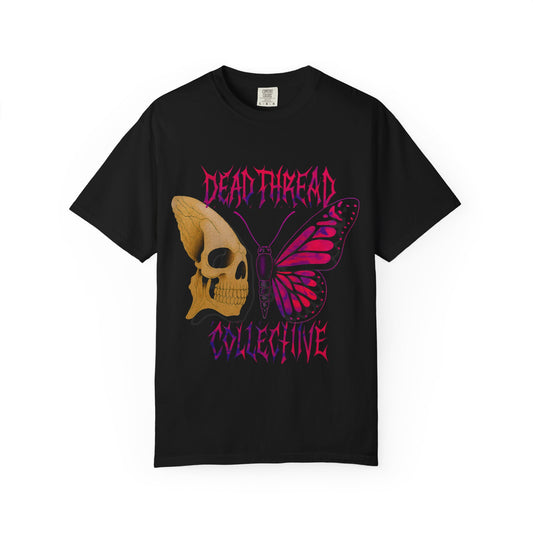 Black t-shirt featuring a jagged skull and vibrant pink-purple butterfly graphic with “Dead Thread Collective” text in stylized gradient font; a symbolic fusion of horror and transformation.